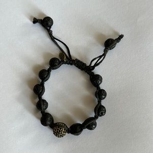 TAI lava rock bracelet with gold studded accent bead.